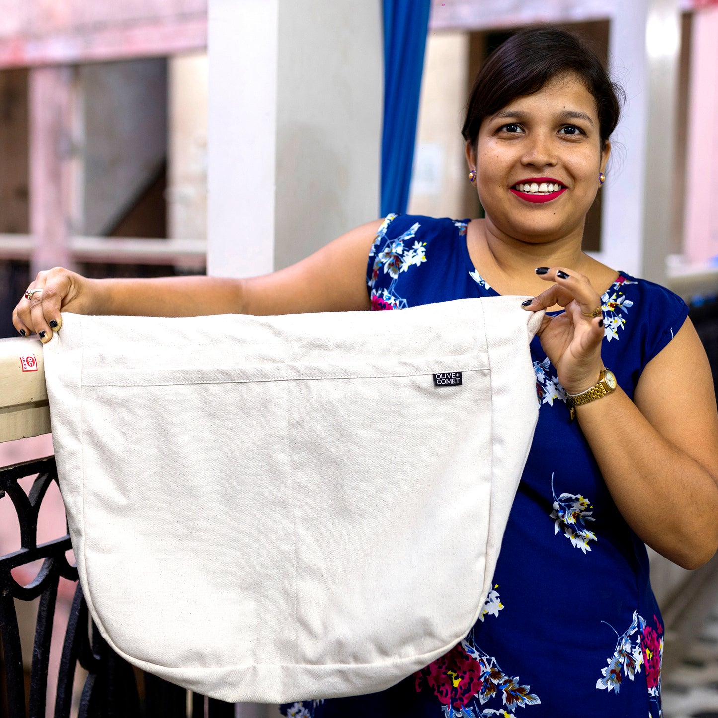 An artisan in India proudly holds up a finished Sonoma bag