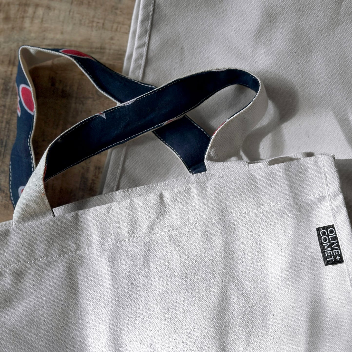 closeup of a Parker bag shows off the blue and red color of an upcycled sari lining on it's handles