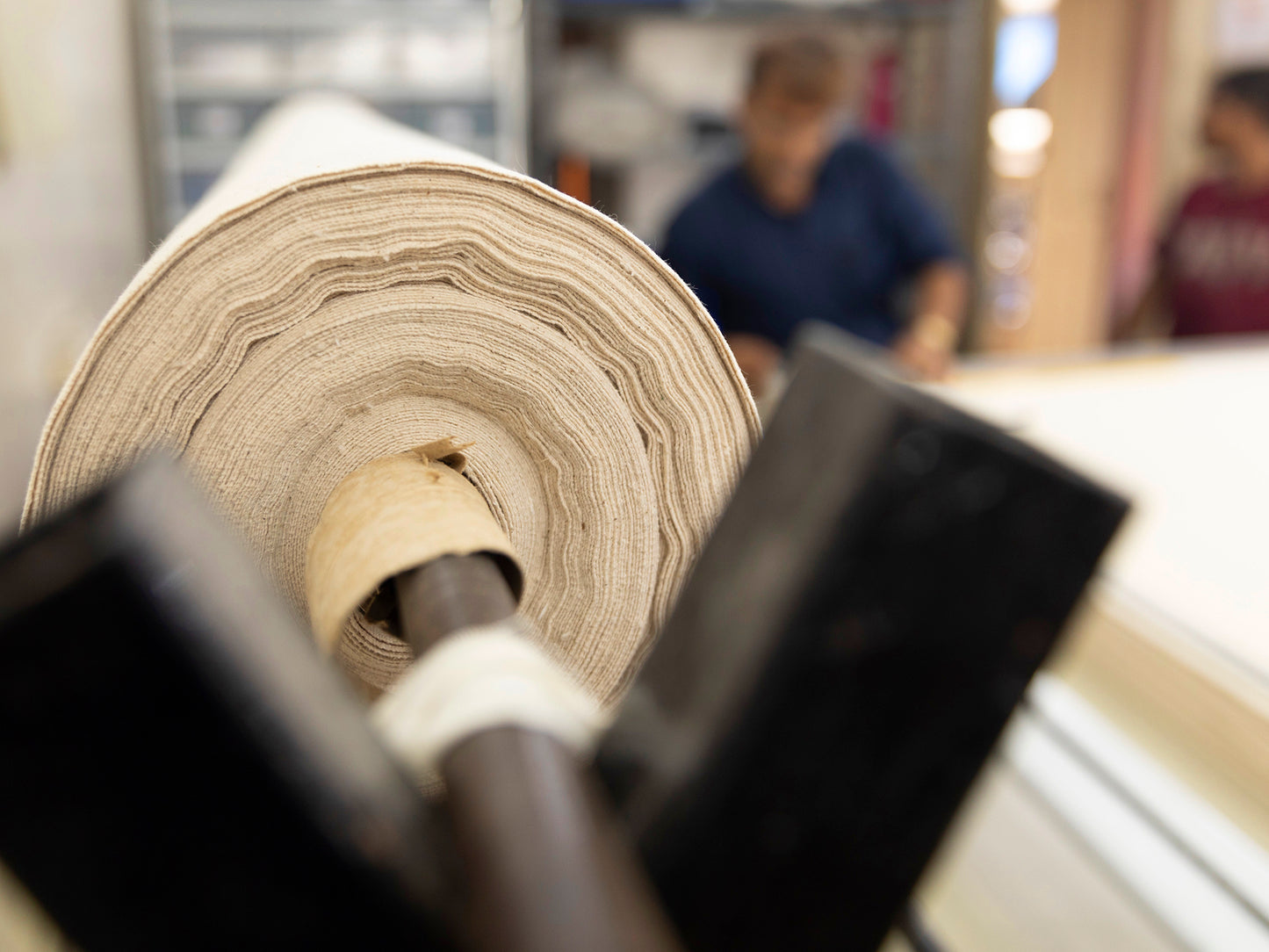 Photo of a roll of GOTS certified organic cotton canvas being prepped at one of our suppliers