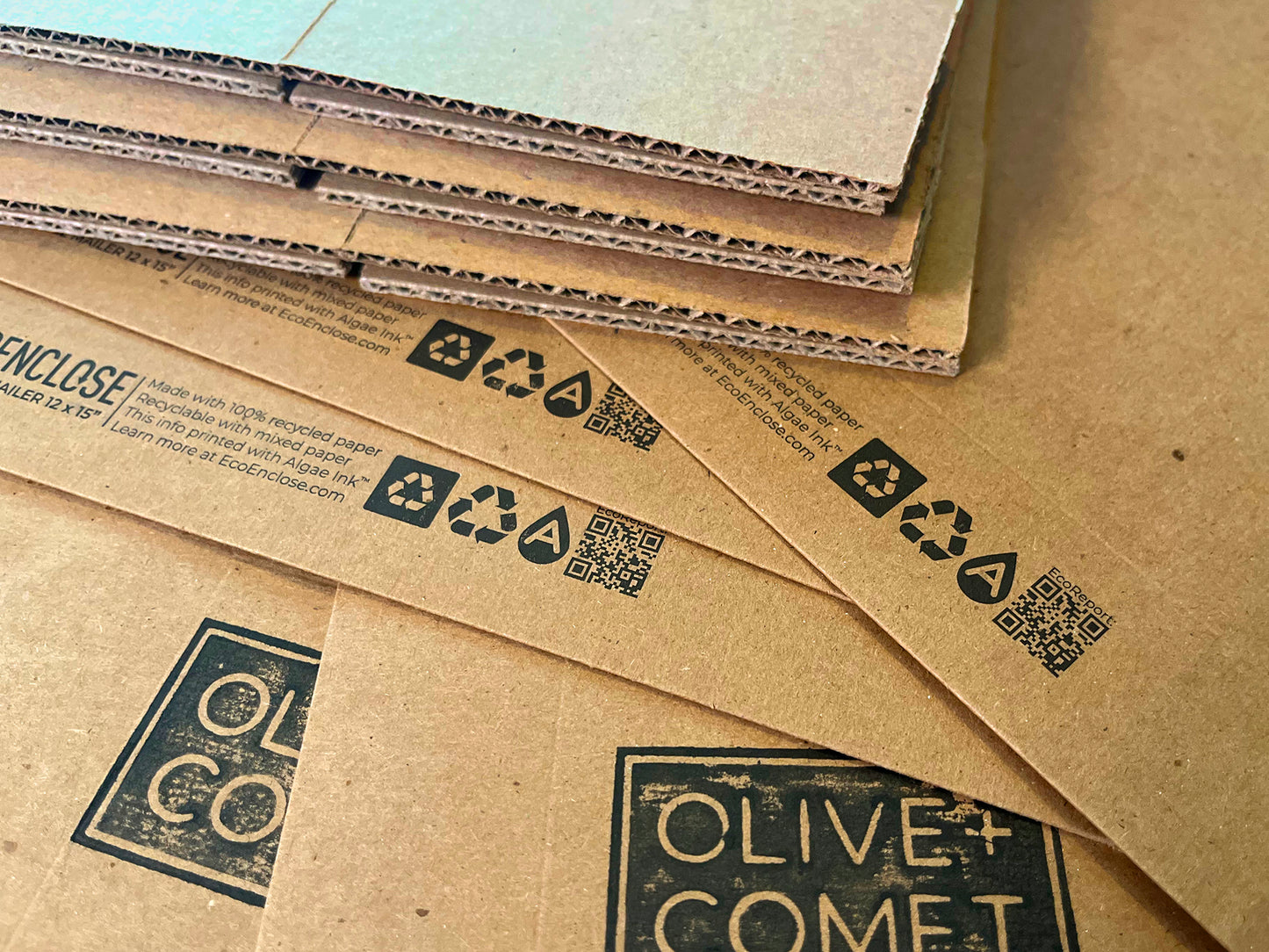 Photo of Olive+Comet recycled packaging shown spread out.