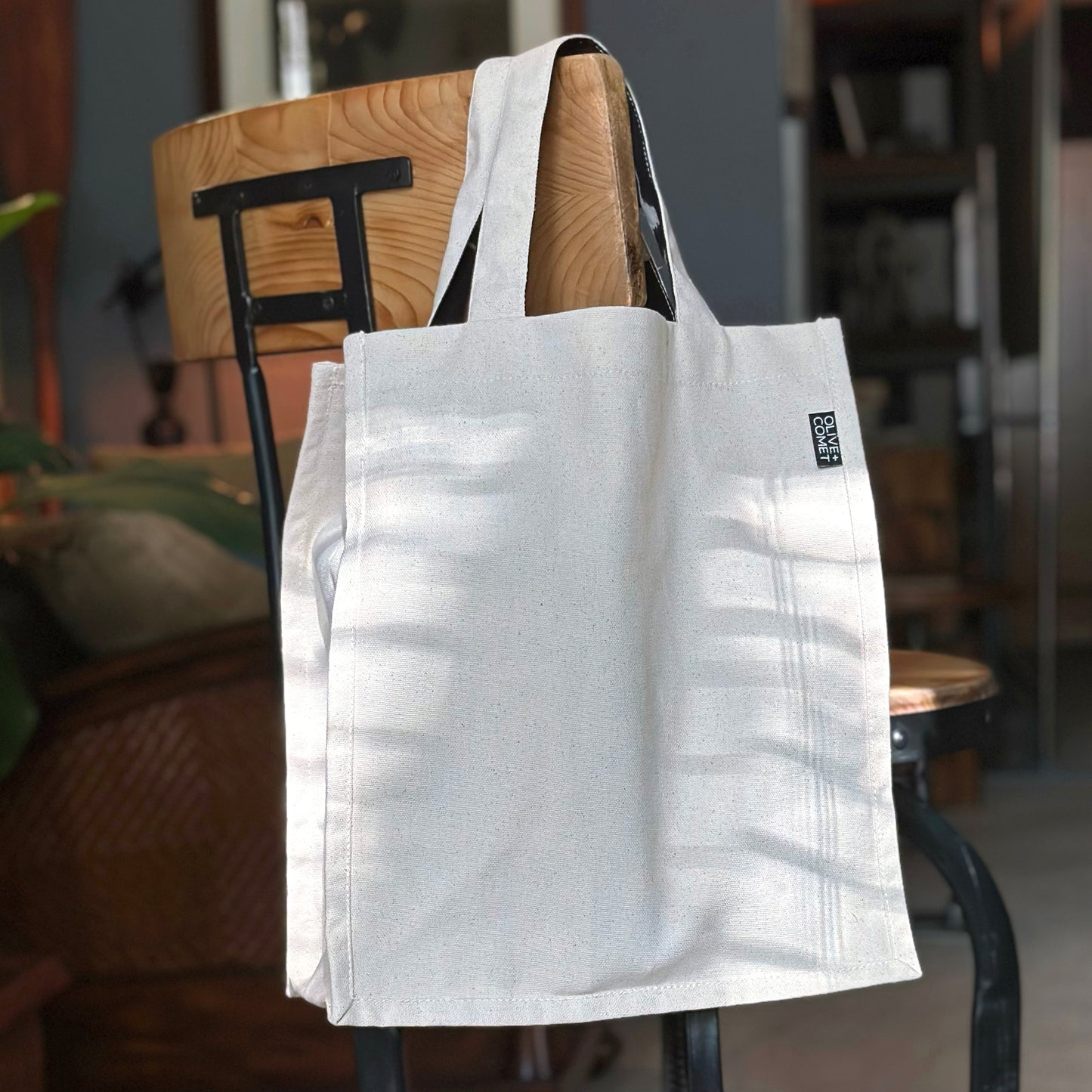 A Parker bag hangs from the back of a vintage stool