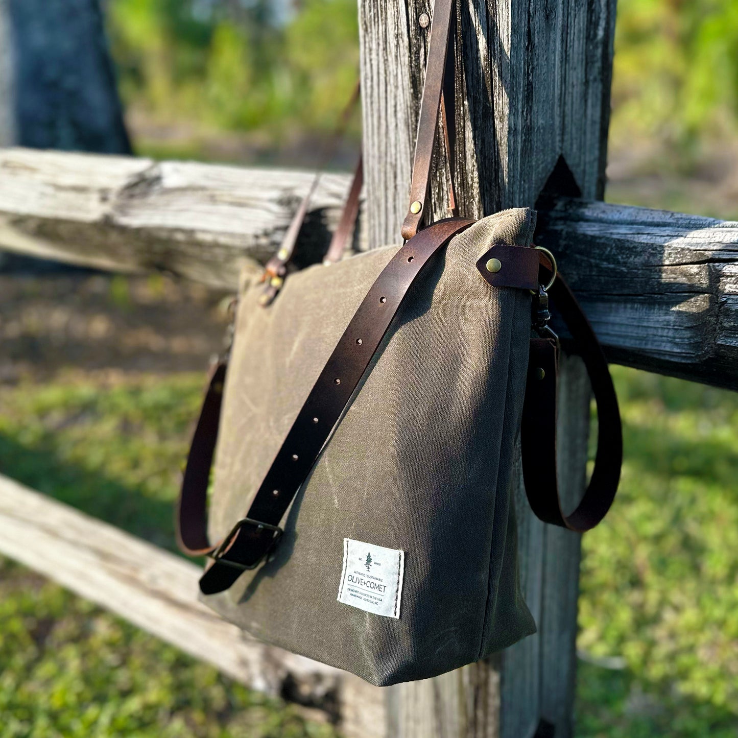 
                  
                    Detail of a Marquesa bag hanging on an old wooden fence
                  
                