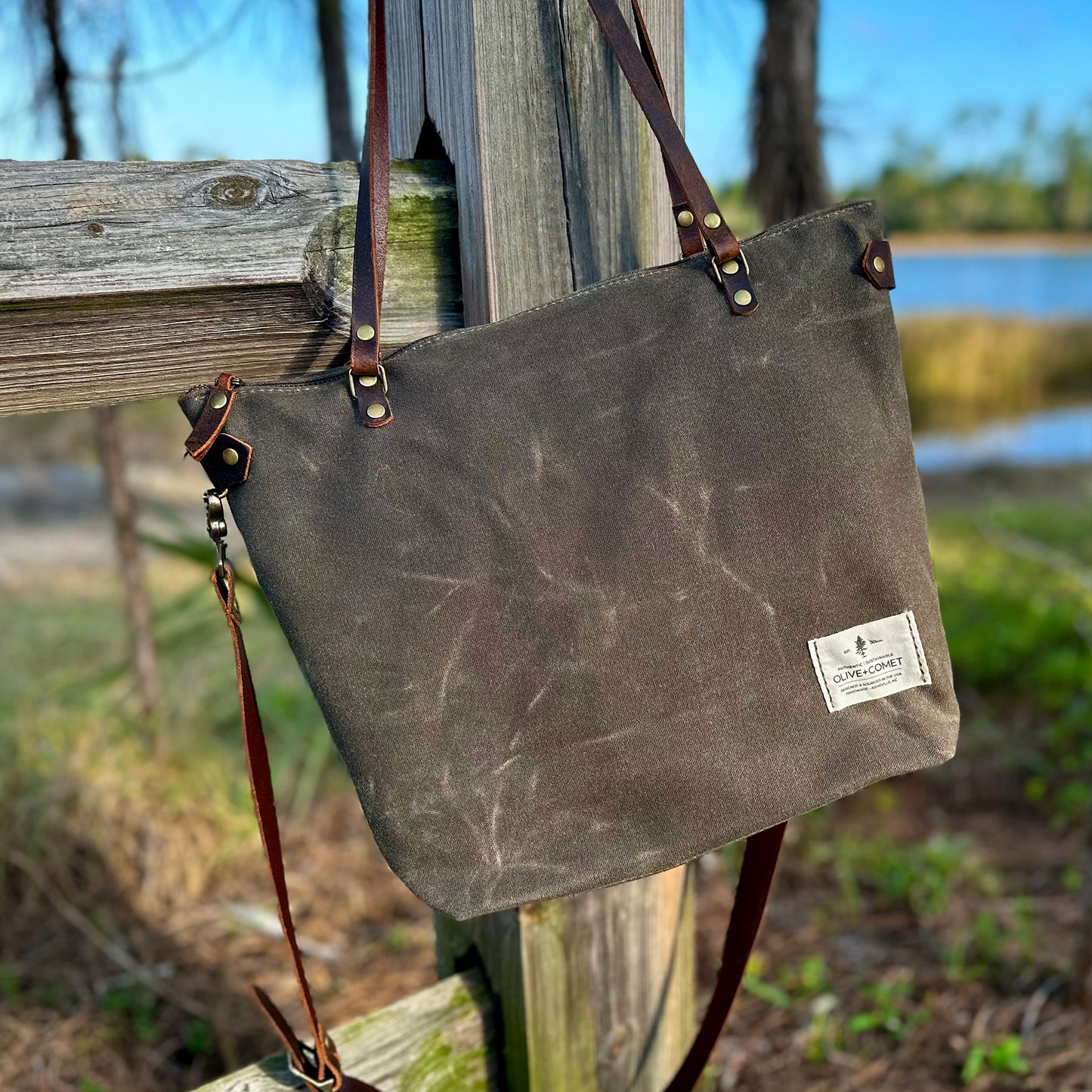 
                  
                    Detail of a Marquesa bag hanging on an old wooden fence
                  
                