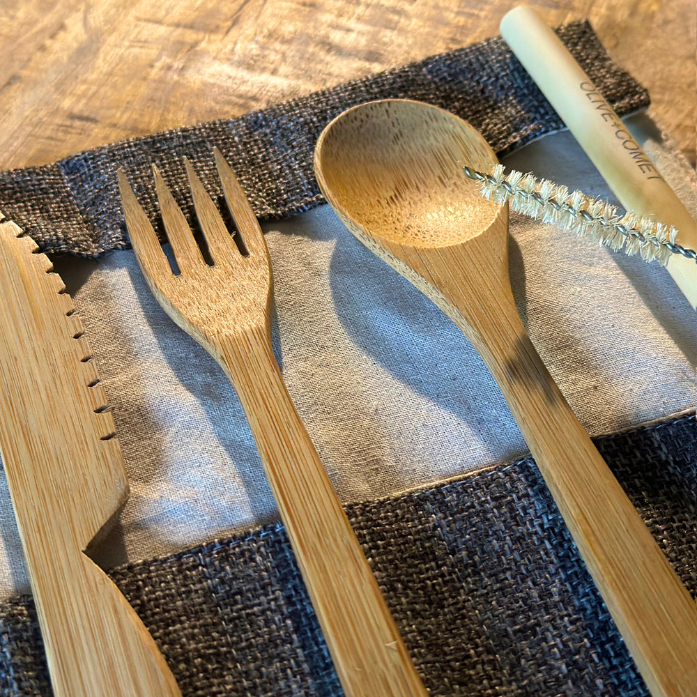 
                  
                    A Sarita bamboo flatware set lies open on a mango wood table
                  
                