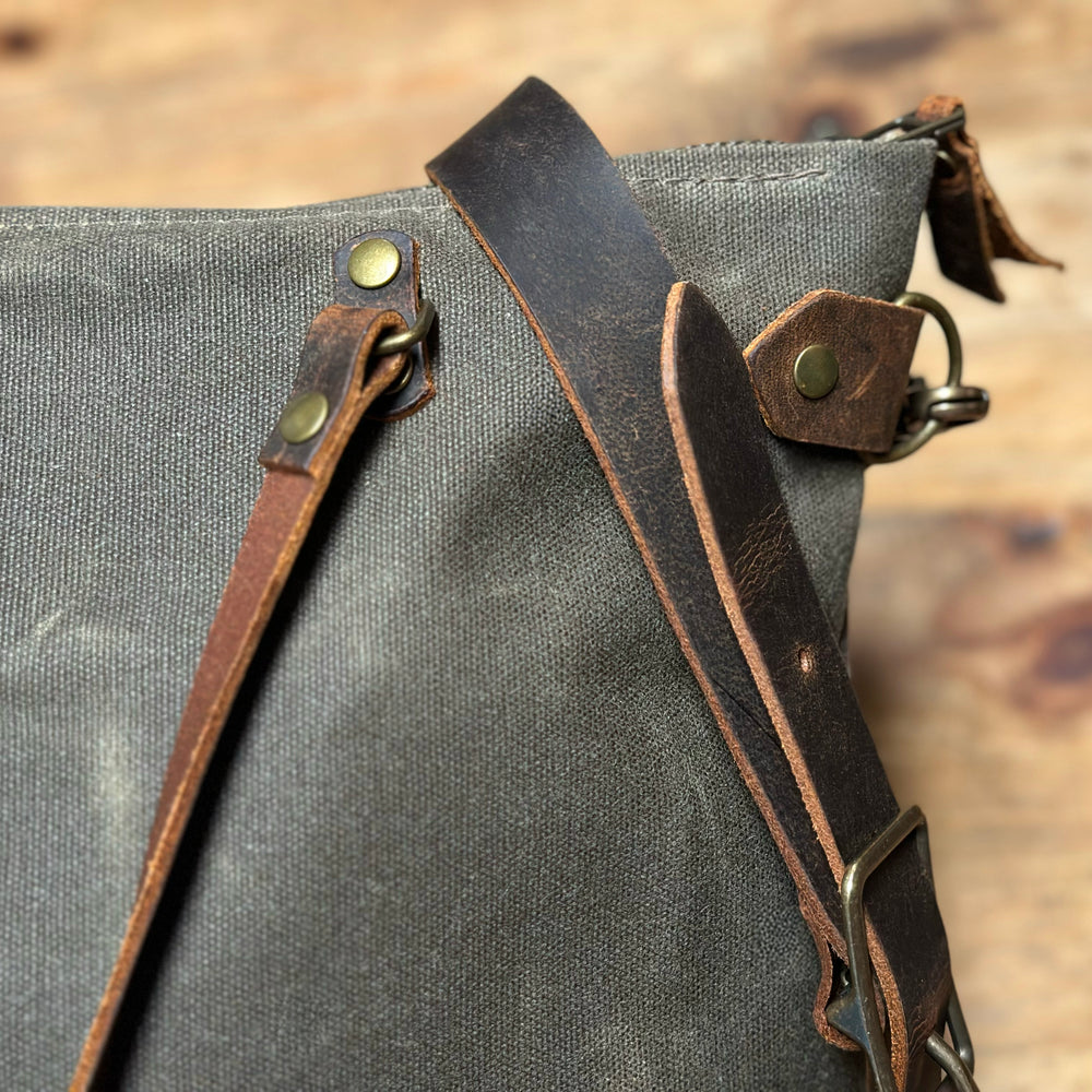 
                  
                    Detail photo of the Olive+Comet Marquesa bag showing leather and brass details
                  
                