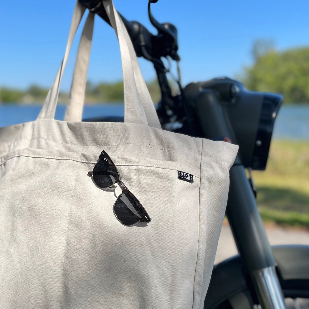 A Sonoma bag hangs on the handlebars of a vintage motorcycle