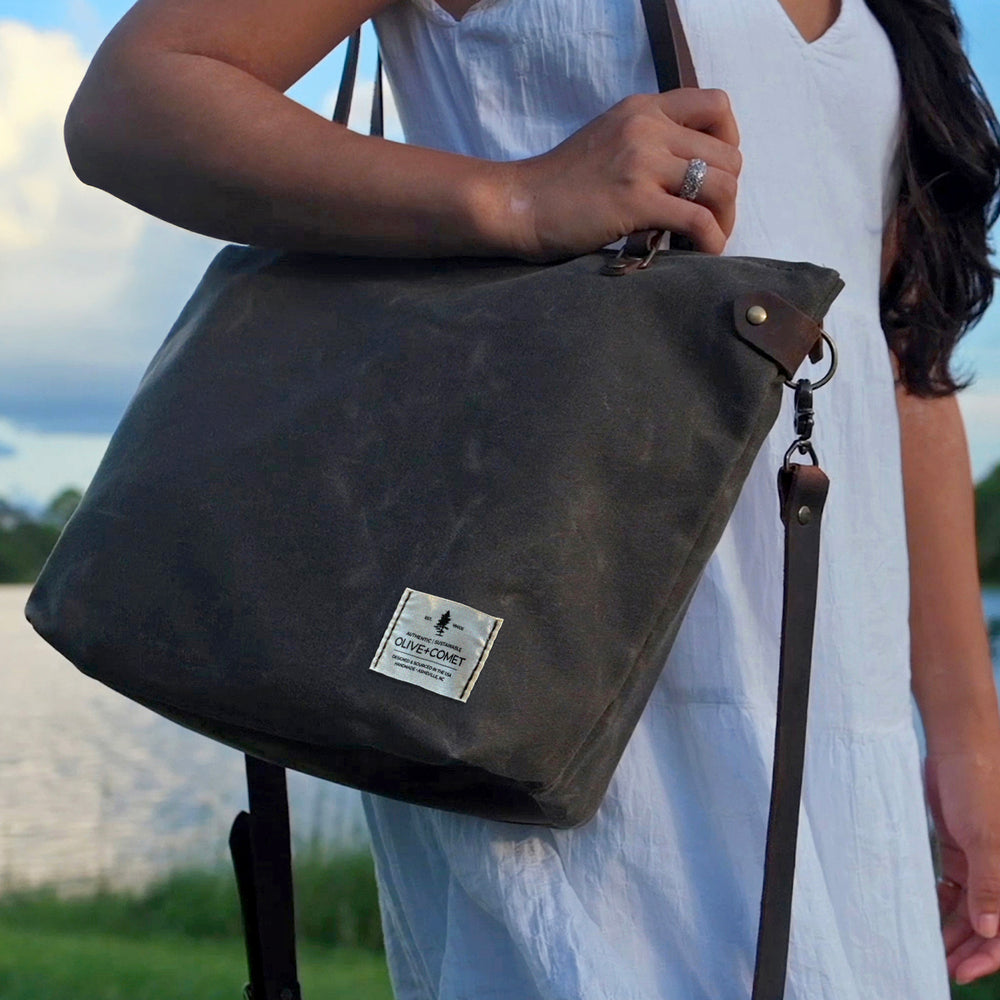 
                  
                    A woman in a white dress walks with a Marquesa bag on her shoulder
                  
                