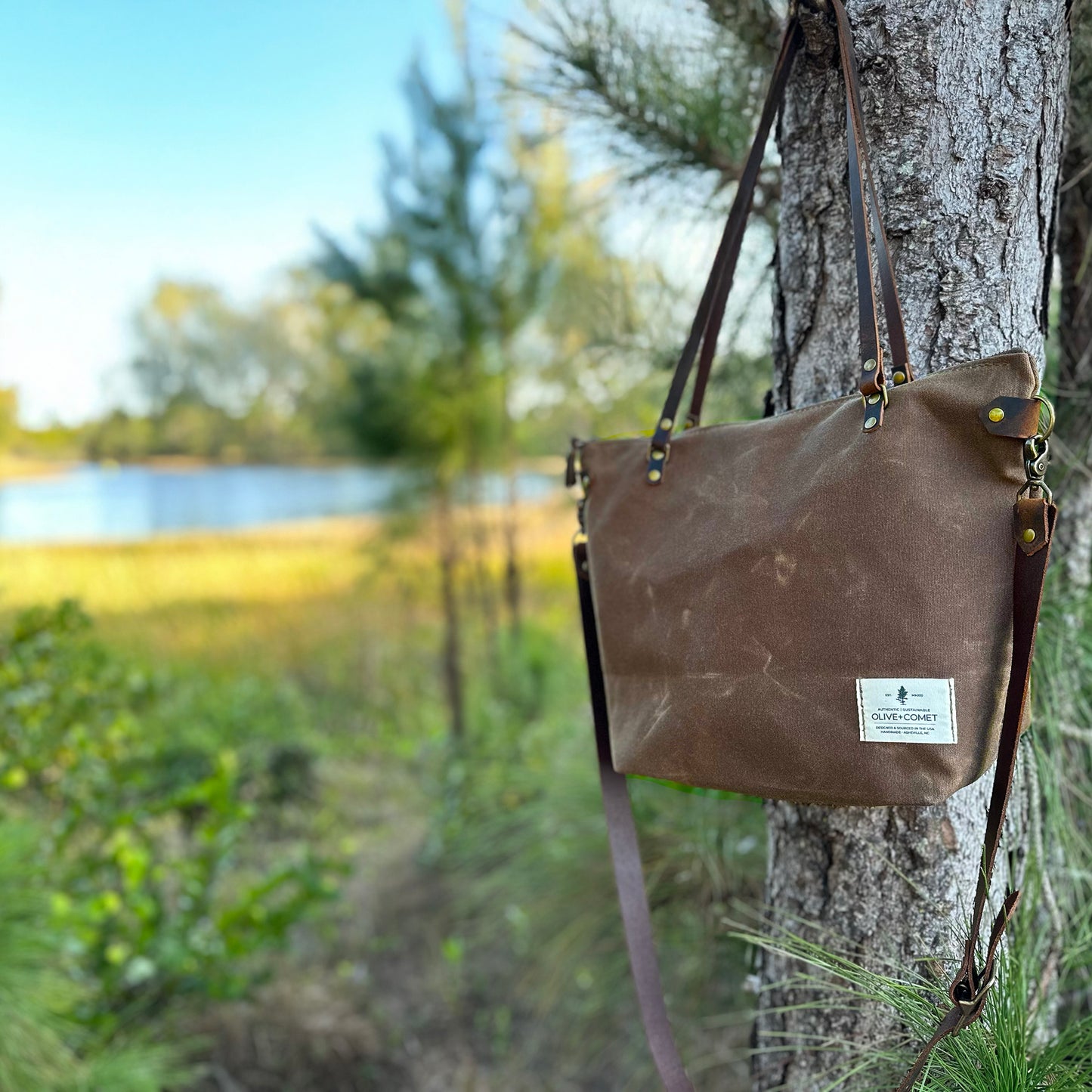 
                  
                    Detail of a marquesa bag hanging on a tree by a lake
                  
                