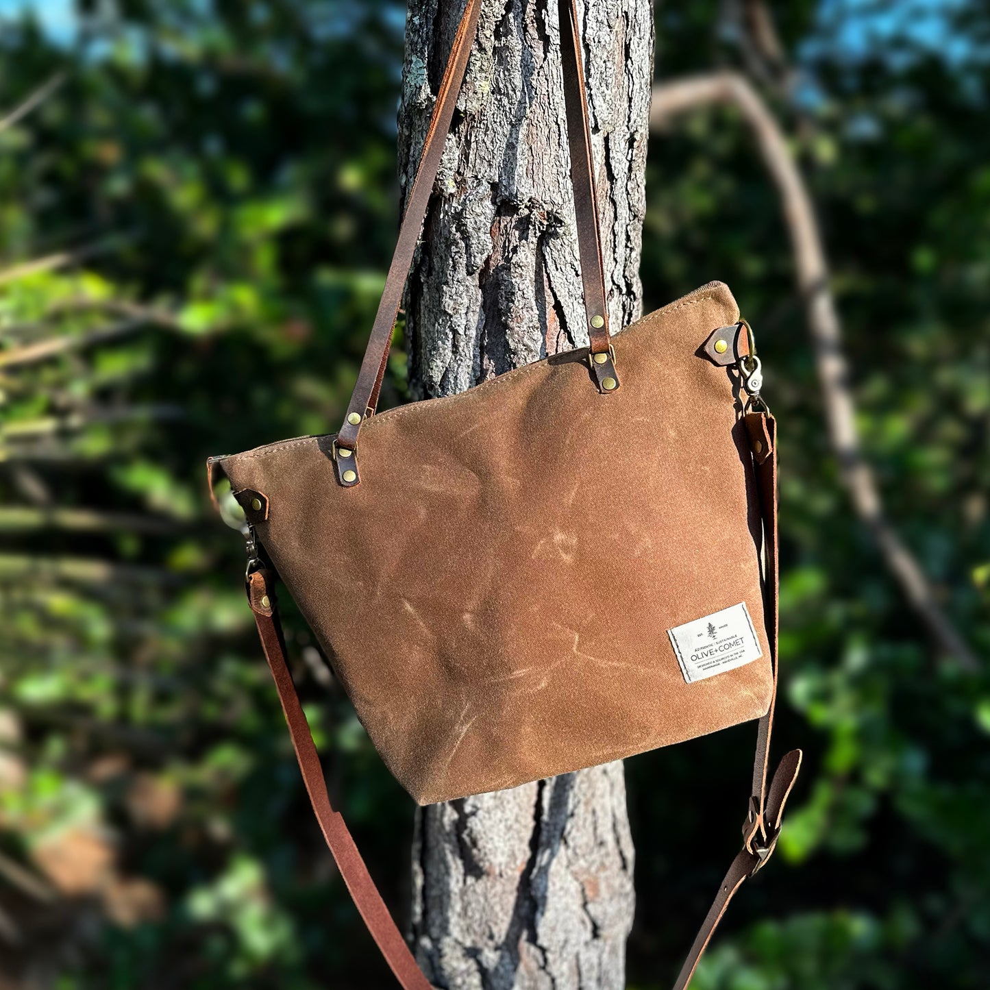 
                  
                    Detail of a Marquesa bag hanging on a tree in a glade
                  
                