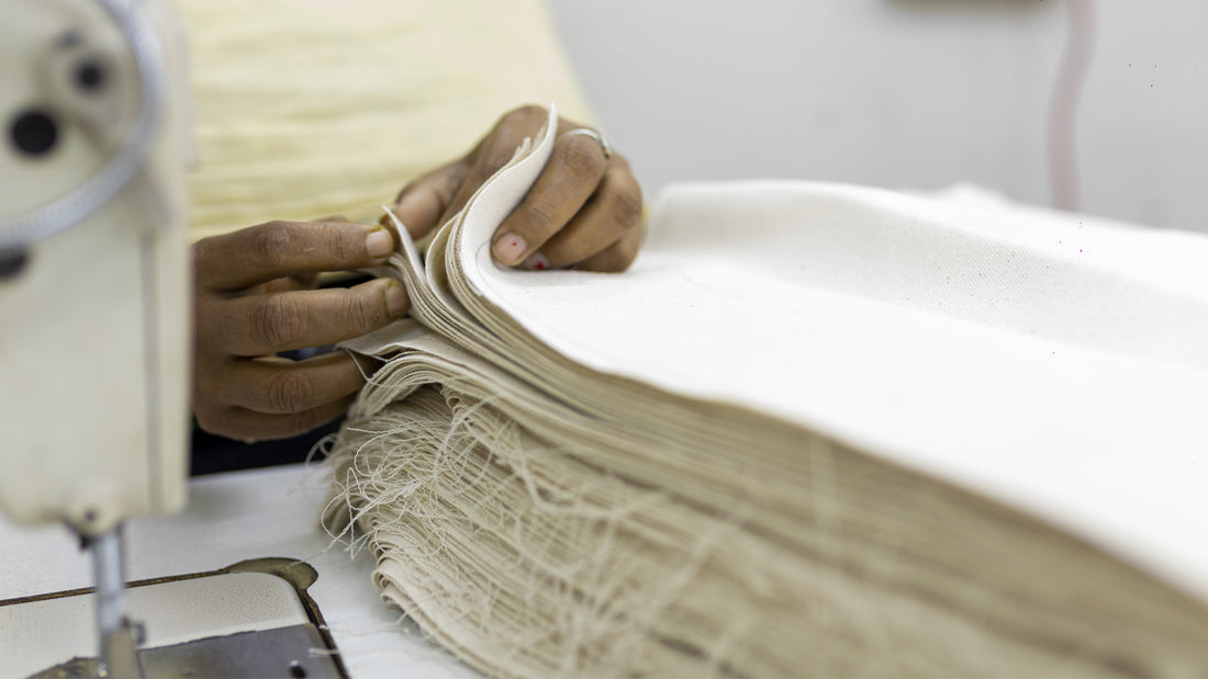A woman producing the Olive+Comet Sonoma bag in a fair trade facility